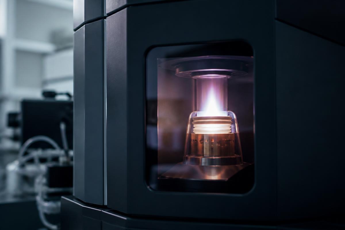 Analyst preparing a sample vial for mass spectrometry